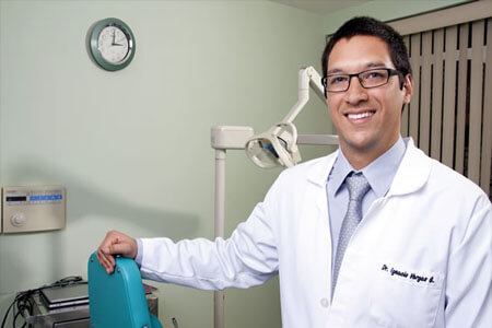 Picture of a dentist smiling back at the camera