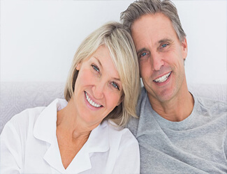 Picture of a senior couple smiling back at the camera